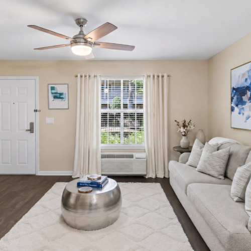 a living room with a couch and a fan