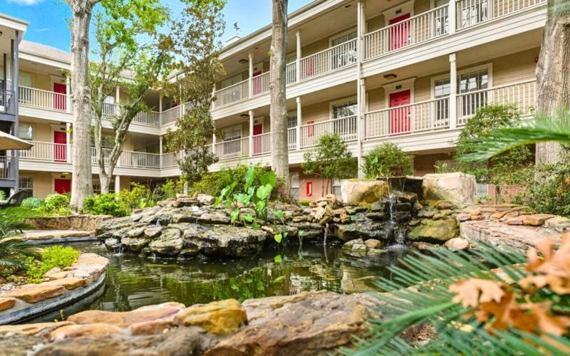 a building with a pond in front of it